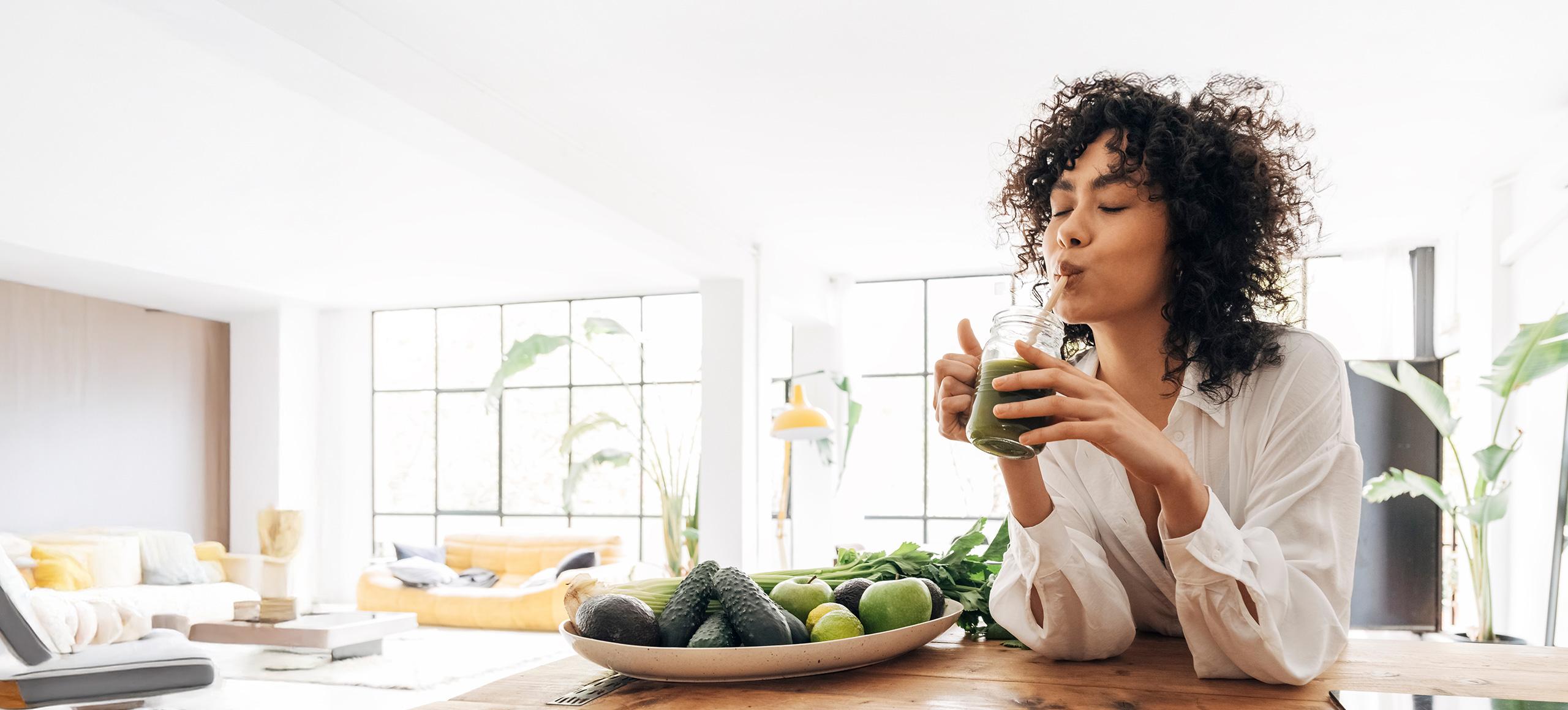 Women drinking from green smoothie