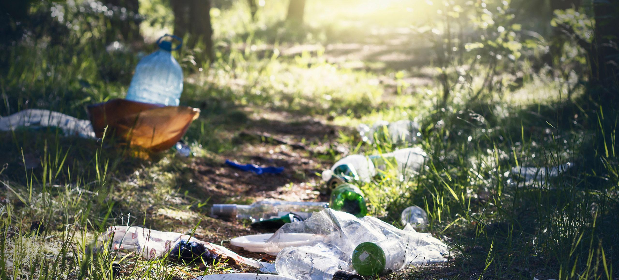 Single-use plastic bottles on grass