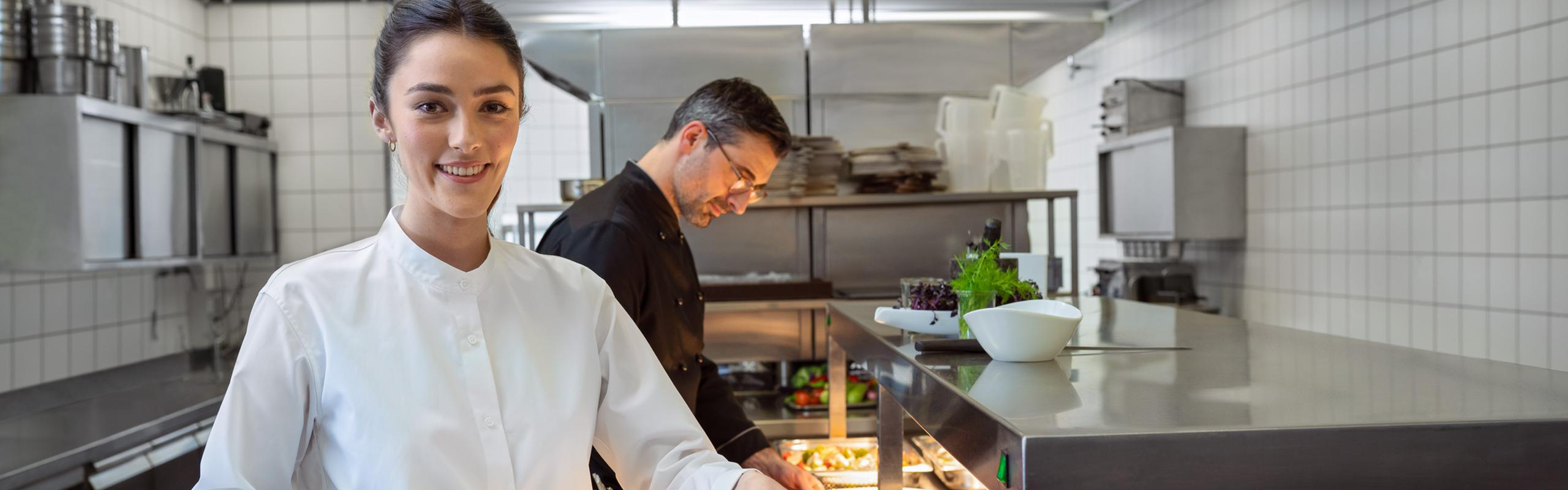 A waitress with a large platter of fish