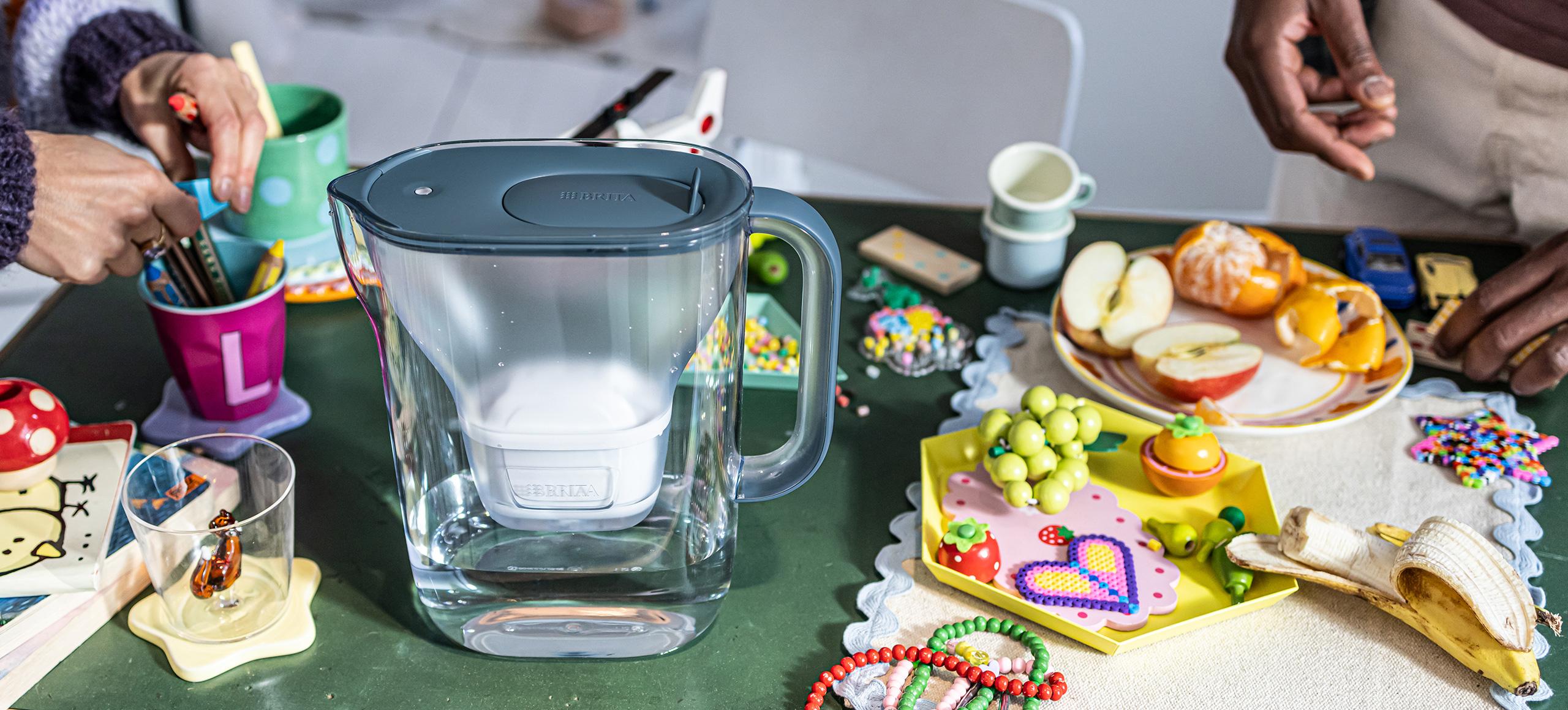 BRITA Style Essential Jug on a messy coffee table