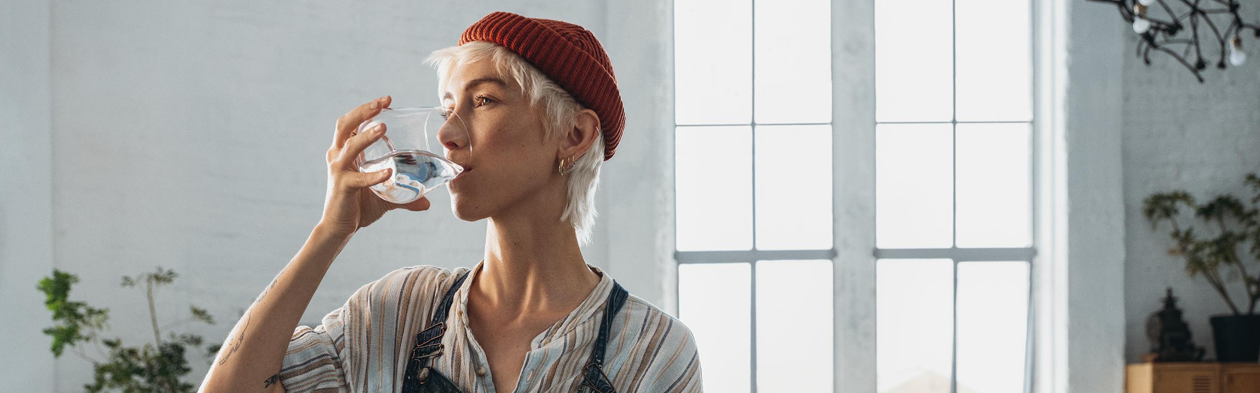 Woman pouring a glass of water from a jug