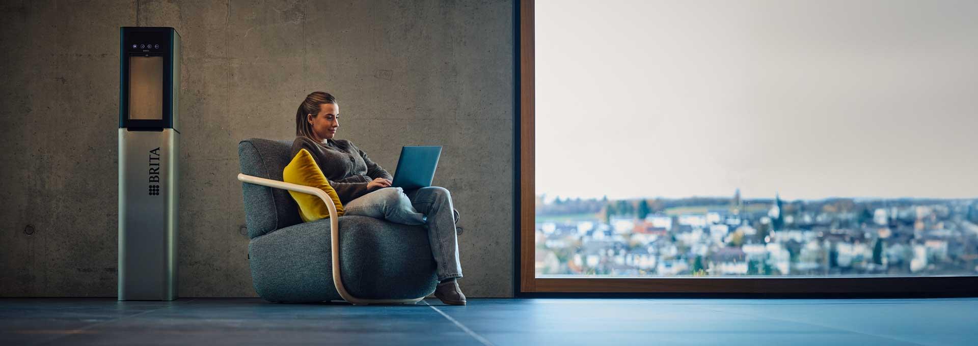 Woman sitting next to water dispenser Top Pro